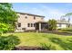 Spacious backyard with lush green grass, mulched flower beds and an enclosed patio dining area at 6356 Mighty Eagle Way, Sarasota, FL 34241