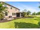 Spacious backyard featuring lush green grass and an enclosed patio, perfect for outdoor relaxation at 6356 Mighty Eagle Way, Sarasota, FL 34241