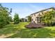 A spacious backyard features a lush lawn, mulched landscape beds and direct access to a covered patio at 6356 Mighty Eagle Way, Sarasota, FL 34241