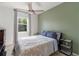 Bedroom features a ceiling fan, neutral colors, and a window providing natural light at 6356 Mighty Eagle Way, Sarasota, FL 34241