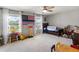 Bright bedroom featuring a ceiling fan, large windows, and charming decor, perfect for a  at 6356 Mighty Eagle Way, Sarasota, FL 34241