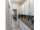Functional Butler's Pantry boasting extra counter space and storage, seamlessly connecting to the nearby office at 6356 Mighty Eagle Way, Sarasota, FL 34241