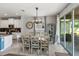 Cozy dining area with stylish chandelier, seating for six, and seamless flow to the modern kitchen at 6356 Mighty Eagle Way, Sarasota, FL 34241