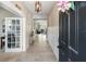 Welcoming foyer with tile flooring, stylish light fixture, and a view into the living area at 6356 Mighty Eagle Way, Sarasota, FL 34241