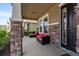 Inviting front porch with stone accents and outdoor furniture, offering a cozy seating area at 6356 Mighty Eagle Way, Sarasota, FL 34241