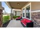 Inviting front porch with stone accents and outdoor furniture, offering a cozy seating area at 6356 Mighty Eagle Way, Sarasota, FL 34241
