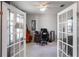 Versatile home office space featuring glass french doors, neutral color palette and plenty of light at 6356 Mighty Eagle Way, Sarasota, FL 34241