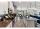 Modern kitchen featuring granite countertops, stainless steel appliances, and a spacious island with seating at 6356 Mighty Eagle Way, Sarasota, FL 34241