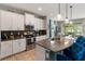 Bright kitchen features white cabinets, stainless appliances, granite counters, and a peninsula island with seating at 6356 Mighty Eagle Way, Sarasota, FL 34241