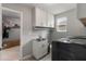 Practical laundry room with modern appliances, storage cabinets, and a utility sink at 6356 Mighty Eagle Way, Sarasota, FL 34241
