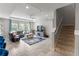 Living room featuring a ceiling fan, large television, stairs, and comfortable seating area at 6356 Mighty Eagle Way, Sarasota, FL 34241