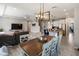 Open-concept kitchen and living room area with dining table and modern lighting fixtures at 6356 Mighty Eagle Way, Sarasota, FL 34241