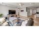 Cozy living room featuring a ceiling fan, large television, and comfortable seating area at 6356 Mighty Eagle Way, Sarasota, FL 34241