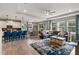 Open floor plan features a living room and kitchen area with large windows and a cozy seating arrangement at 6356 Mighty Eagle Way, Sarasota, FL 34241