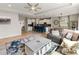 Open floor plan features a living room and kitchen area with large windows and a cozy seating arrangement at 6356 Mighty Eagle Way, Sarasota, FL 34241