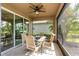 Covered patio features a ceiling fan and table with chairs, perfect for outdoor dining and entertaining at 6356 Mighty Eagle Way, Sarasota, FL 34241