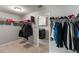 Spacious walk-in closet with shelving and rods for organized storage, and laundry room is visible in the background at 6356 Mighty Eagle Way, Sarasota, FL 34241