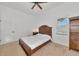 Neutral bedroom featuring a wooden bed frame, carpet floors, a window with blinds, and a ceiling fan at 681 Avenida De Mayo, Sarasota, FL 34242