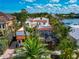 Stunning two-story home featuring a red tile roof, tropical landscaping and screened-in pool area at 681 Avenida De Mayo, Sarasota, FL 34242