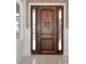 Stunning, custom wood front door and sidelights with tile trim and accents at 681 Avenida De Mayo, Sarasota, FL 34242