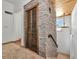 Hallway featuring stone accent wall, wood plank ceiling, and staircase leading to upper level of the house at 681 Avenida De Mayo, Sarasota, FL 34242