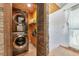Convenient laundry room with stacked washer and dryer, shelving for storage, and stylish stone accents at 681 Avenida De Mayo, Sarasota, FL 34242