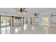 Bright living room features neutral tile flooring, ceiling fans, and abundant natural light from the multiple sliding doors at 681 Avenida De Mayo, Sarasota, FL 34242
