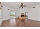 Spacious living area with hardwood floors, cozy fireplace, and sliding glass doors leading to a patio or balcony at 681 Avenida De Mayo, Sarasota, FL 34242