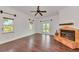 Cozy living room with hardwood floors, a decorative fireplace, and large windows offering serene outdoor views at 681 Avenida De Mayo, Sarasota, FL 34242