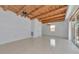 Open living space with wood beam ceiling, tile floors and sliding doors to the pool area at 681 Avenida De Mayo, Sarasota, FL 34242