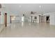 Expansive living area with white tile floors, beamed ceilings, and an open layout great for entertaining at 681 Avenida De Mayo, Sarasota, FL 34242