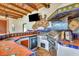 Outdoor kitchen includes stainless steel appliances, grill, sink, refrigerator and beautiful tile at 681 Avenida De Mayo, Sarasota, FL 34242