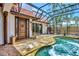 Outdoor pool area featuring a private pool, unique design, and tile floor in an enclosed lanai at 681 Avenida De Mayo, Sarasota, FL 34242
