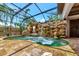 A beautifully landscaped pool with a unique rock waterfall feature and enclosure at 681 Avenida De Mayo, Sarasota, FL 34242