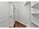 Well-organized walk-in closet featuring custom shelving and hardwood floors providing ample storage space at 681 Avenida De Mayo, Sarasota, FL 34242