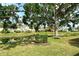 Lush backyard with pond, landscaping, mature trees, and a serene setting at 7124 Rue De Palisades # 21, Sarasota, FL 34238