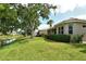 Picturesque backyard with pond, manicured lawn, landscaping, and view of the home at 7124 Rue De Palisades # 21, Sarasota, FL 34238