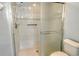 Tiled walk-in shower stall with sliding door and grab bar for safety and accessibility at 7124 Rue De Palisades # 21, Sarasota, FL 34238