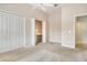 Bedroom features carpeting, a ceiling fan, closet, and a nook with built-in desk at 7124 Rue De Palisades # 21, Sarasota, FL 34238