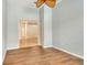 Bedroom features wood floors, a ceiling fan, and a view into another room with a chandelier at 7124 Rue De Palisades # 21, Sarasota, FL 34238