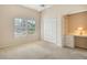 Bedroom boasts a window, closet, carpet, ceiling fan, and built-in desk at 7124 Rue De Palisades # 21, Sarasota, FL 34238