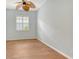 This bedroom features a window with blinds, wood floors, and a ceiling fan at 7124 Rue De Palisades # 21, Sarasota, FL 34238