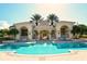 Stunning community pool with covered seating areas and beautifully landscaped with palm trees at 7124 Rue De Palisades # 21, Sarasota, FL 34238