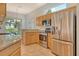 Modern kitchen boasts stainless steel appliances, granite counters, and light wood cabinets at 7124 Rue De Palisades # 21, Sarasota, FL 34238