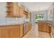 Bright kitchen featuring granite countertops, stainless steel appliances, and natural wood cabinetry at 7124 Rue De Palisades # 21, Sarasota, FL 34238