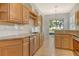 Bright kitchen featuring granite countertops, stainless steel appliances, and natural wood cabinetry at 7124 Rue De Palisades # 21, Sarasota, FL 34238