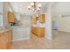 Open-concept kitchen featuring a breakfast bar and seamlessly connecting to the living area at 7124 Rue De Palisades # 21, Sarasota, FL 34238