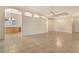 A spacious living area boasts a large built in cabinet, tile flooring, and custom light fixtures at 7124 Rue De Palisades # 21, Sarasota, FL 34238