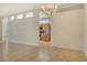 Bright living room featuring neutral paint, a modern chandelier, and arched doorways at 7124 Rue De Palisades # 21, Sarasota, FL 34238