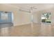 Bright living room features tile floors, a ceiling fan, and sliding doors to a patio at 7124 Rue De Palisades # 21, Sarasota, FL 34238